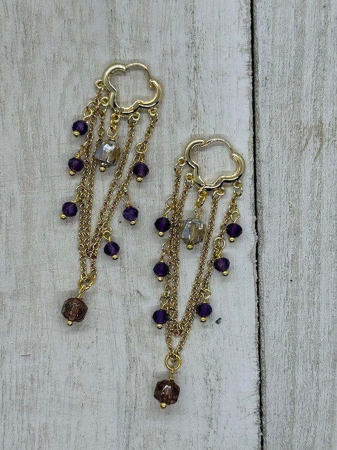 A side profile of the earrings, displaying the depth and design of the beadwork around the central amethyst gemstone, adding sophistication and luxury to the piece.