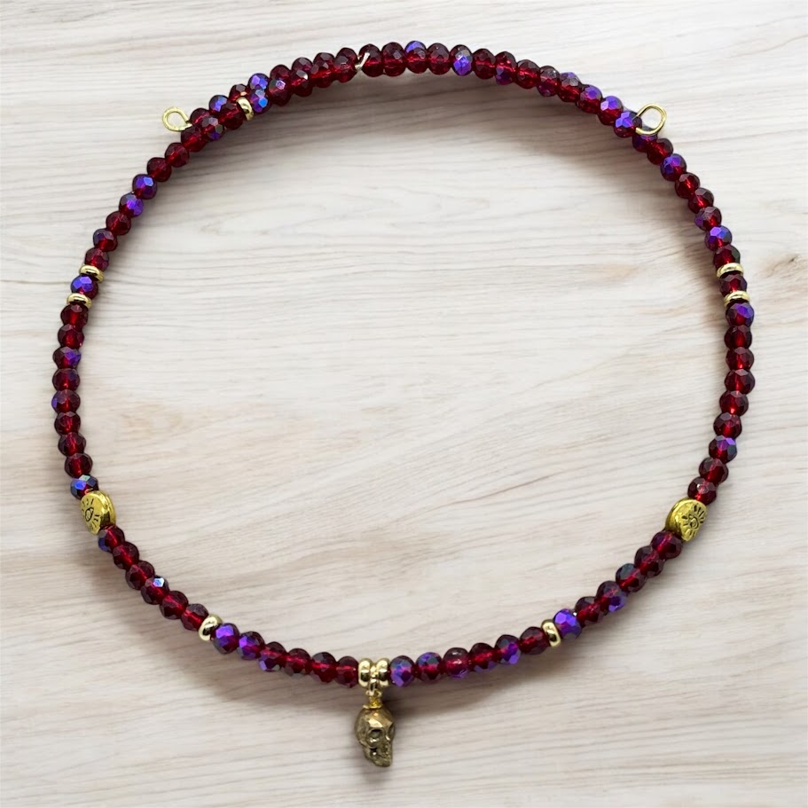 A close-up of the handcrafted Crimson Rebel Skull Beaded Choker, showcasing intricate beading with a skull charm at the center. The choker features a combination of bold and elegant design elements.
