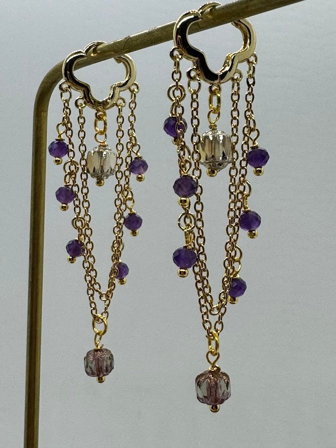 The Amethyst Baroque Earrings worn on the ear, highlighting the vibrant purple hues of the amethyst gemstone and the elegant, detailed beadwork of the earrings.