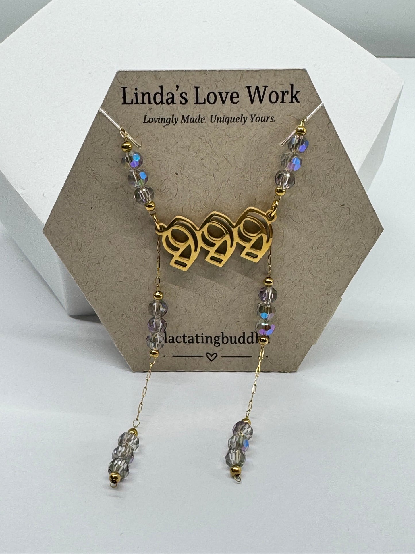 Gold necklace with 999 pendant on a branded card