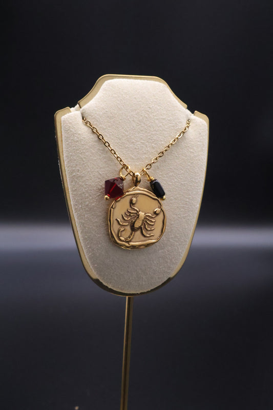 Gold brooch with a decorative design on a dark background