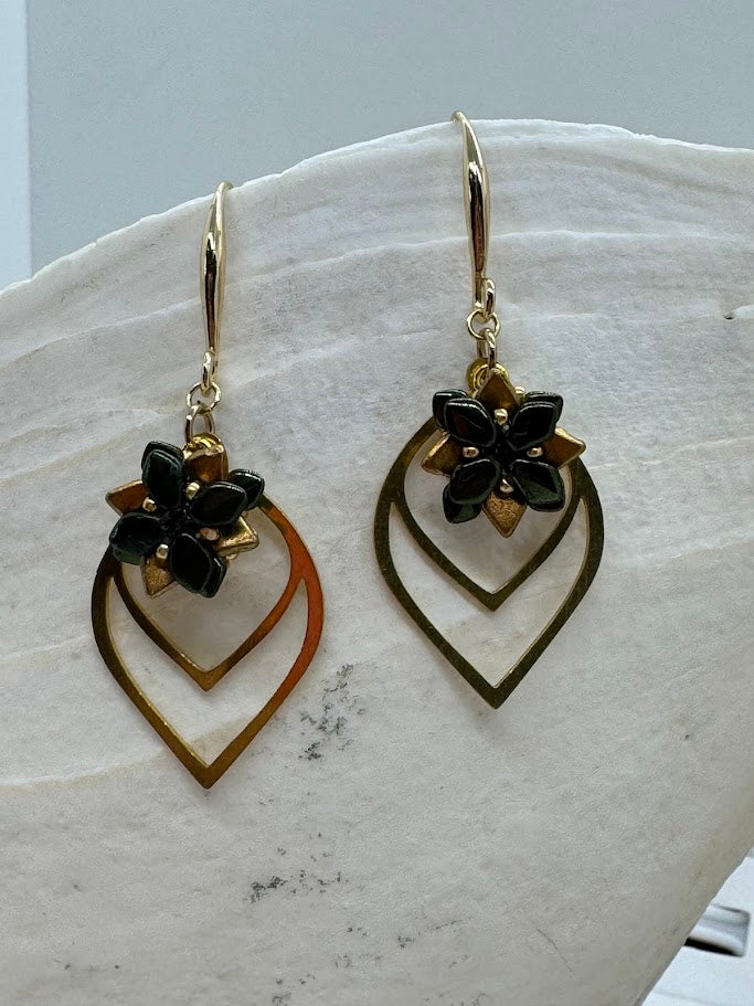 Succulent petal earrings worn outdoors in natural light, with garden or greenery in the background, emphasizing their botanical theme.