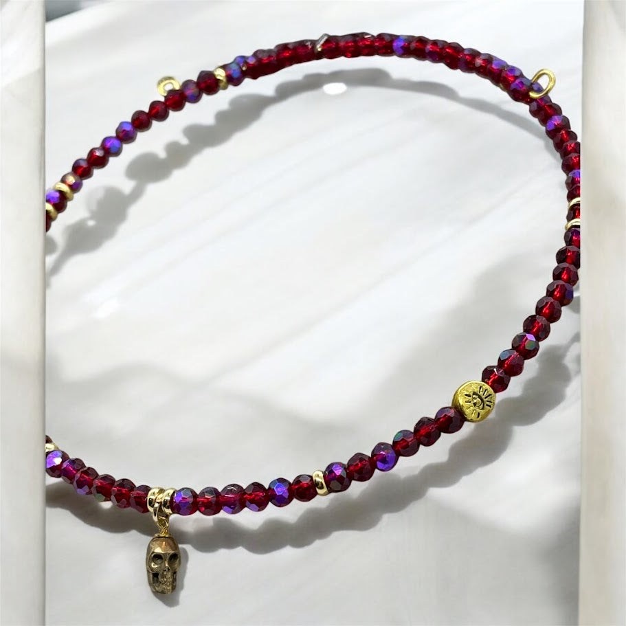 The Crimson Rebel Skull Beaded Choker worn around the neck, highlighting its flexibility and comfortable fit. The skull charm stands out against the vibrant beads, giving the accessory an edgy yet sophisticated look.