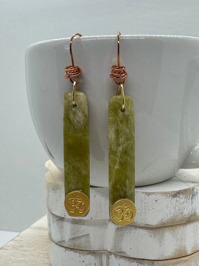 Close-up image of the gemstone, highlighting the clarity, cut, and natural color variations of the stone in the earring setting.