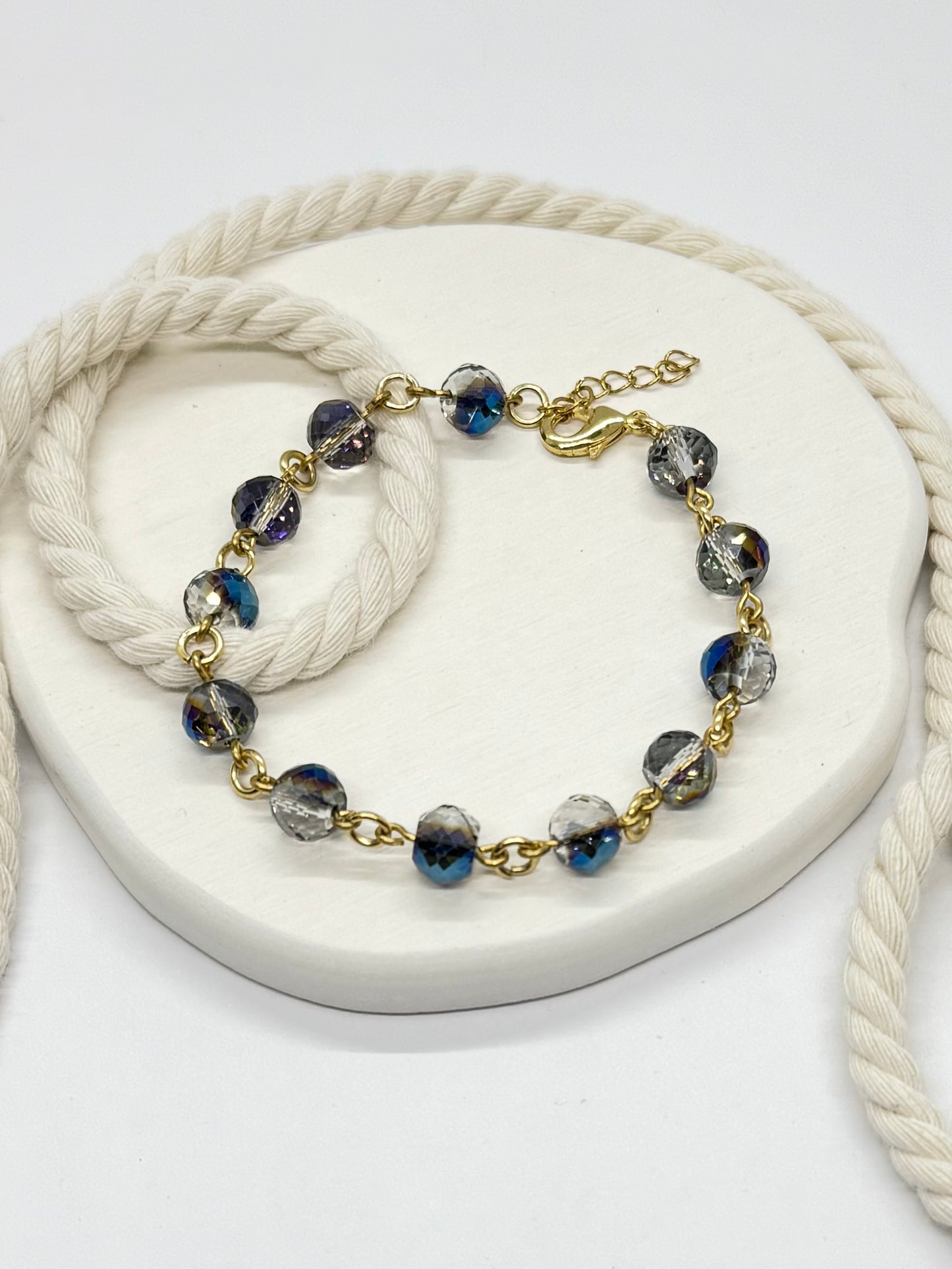 Bracelet with blue and gray beads on a white surface