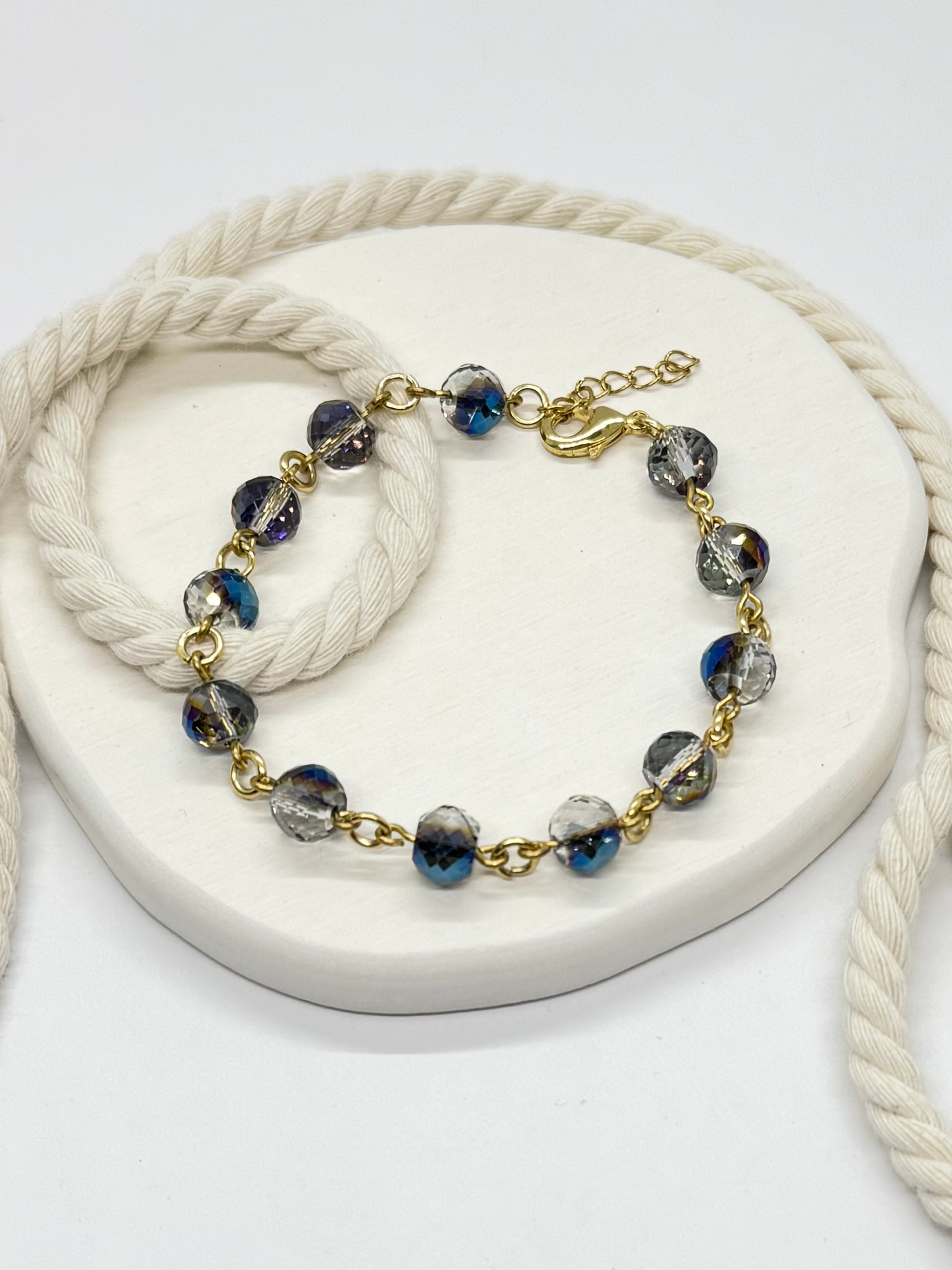 Bracelet with blue and gray beads on a white surface