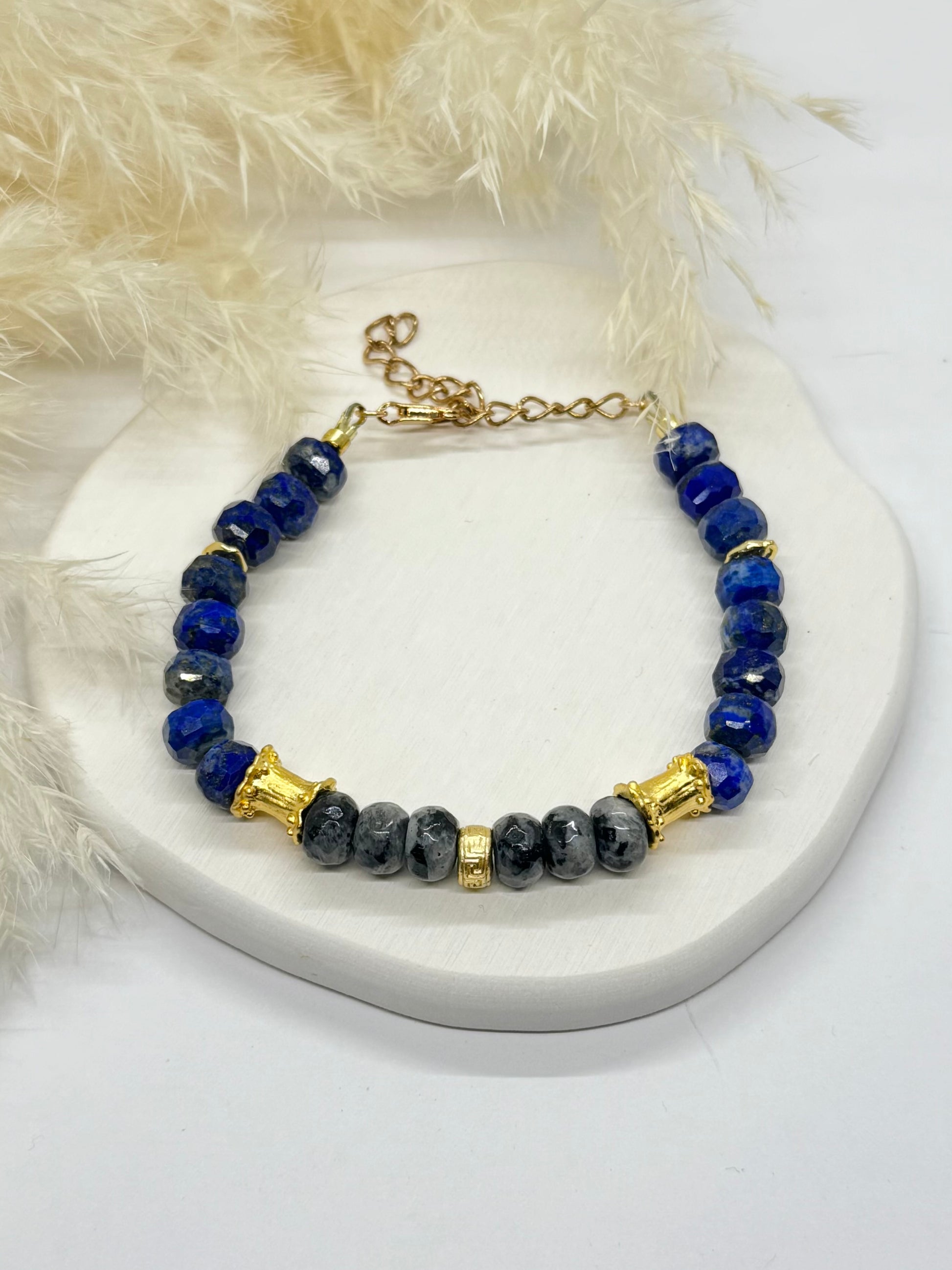 Bracelet with blue and black beads on a white surface