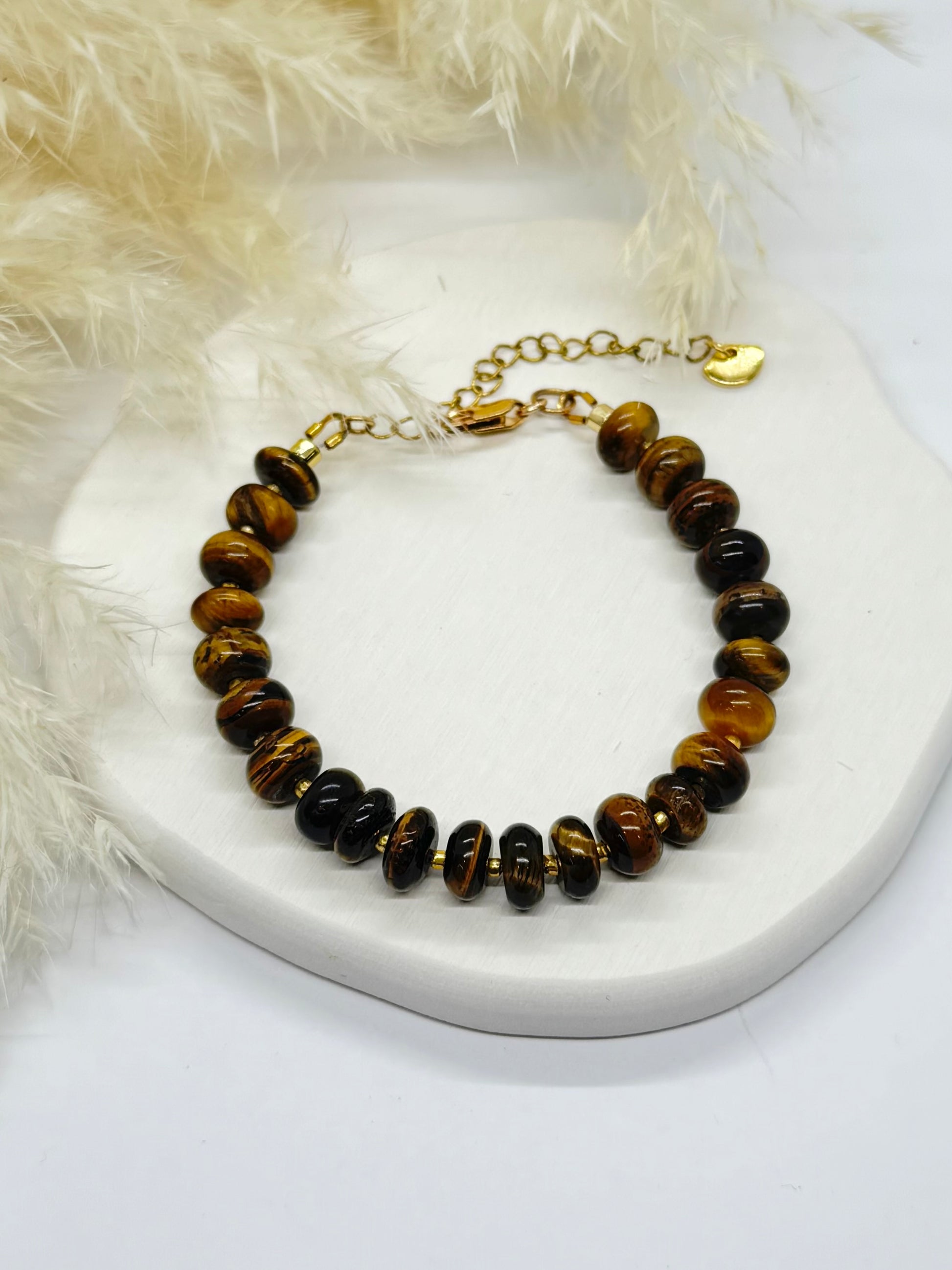 Bracelet with brown and black beaded design on a white surface