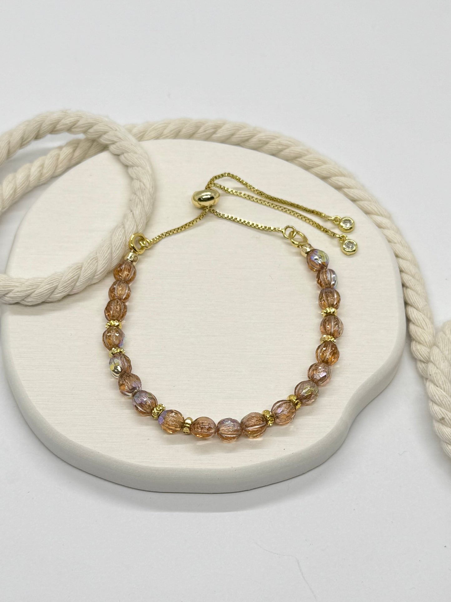 Beaded bracelet on a white stone surface with a natural light background