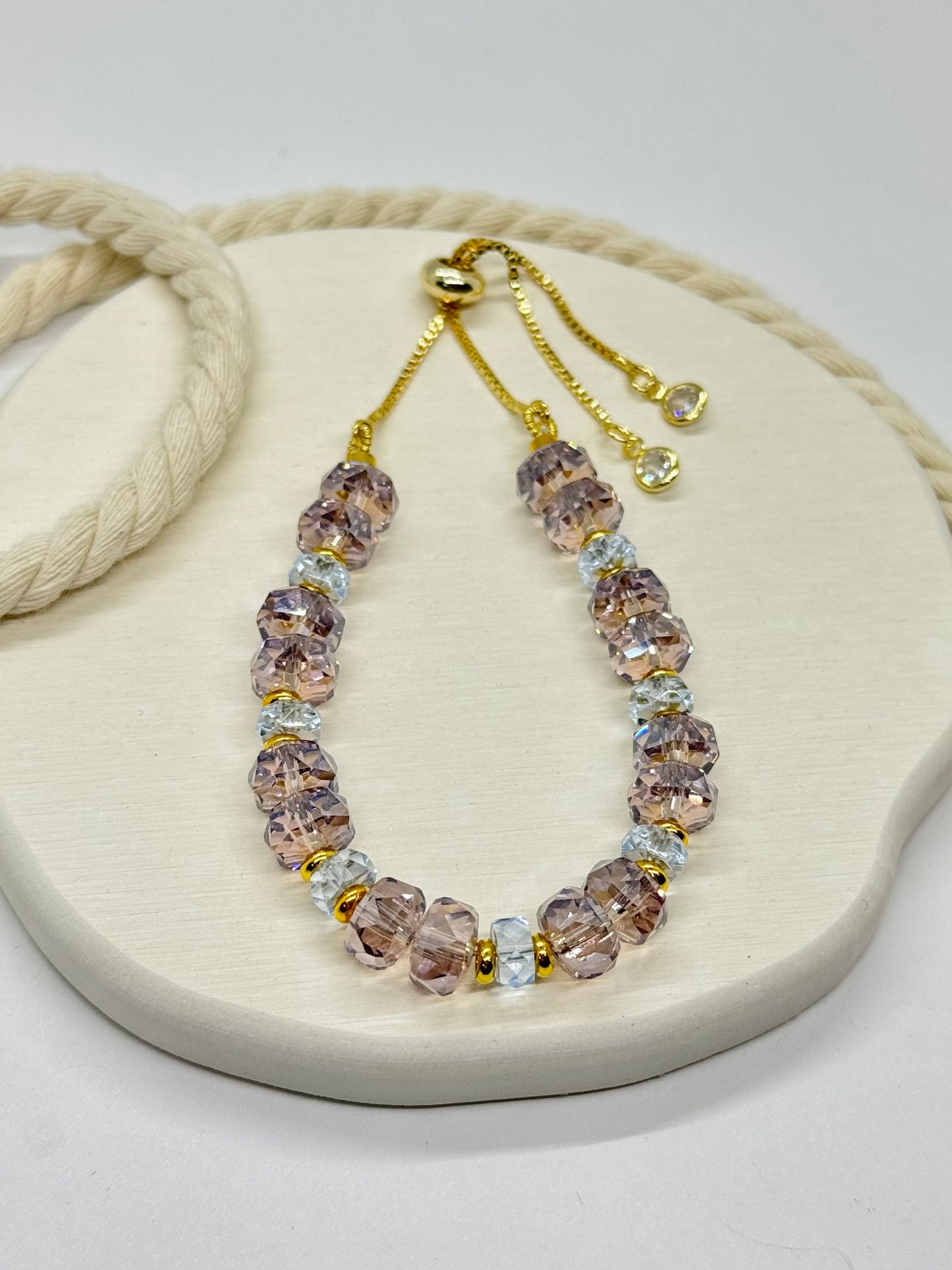 Necklace with pink and gold beads on a white background