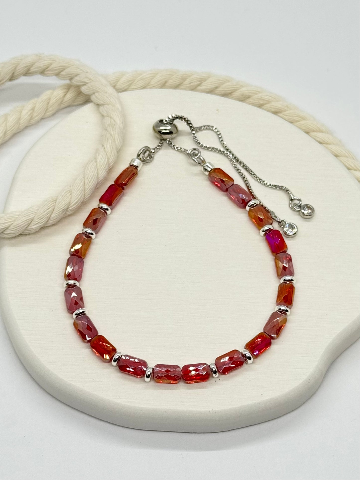 Bracelet with red beads on a white surface