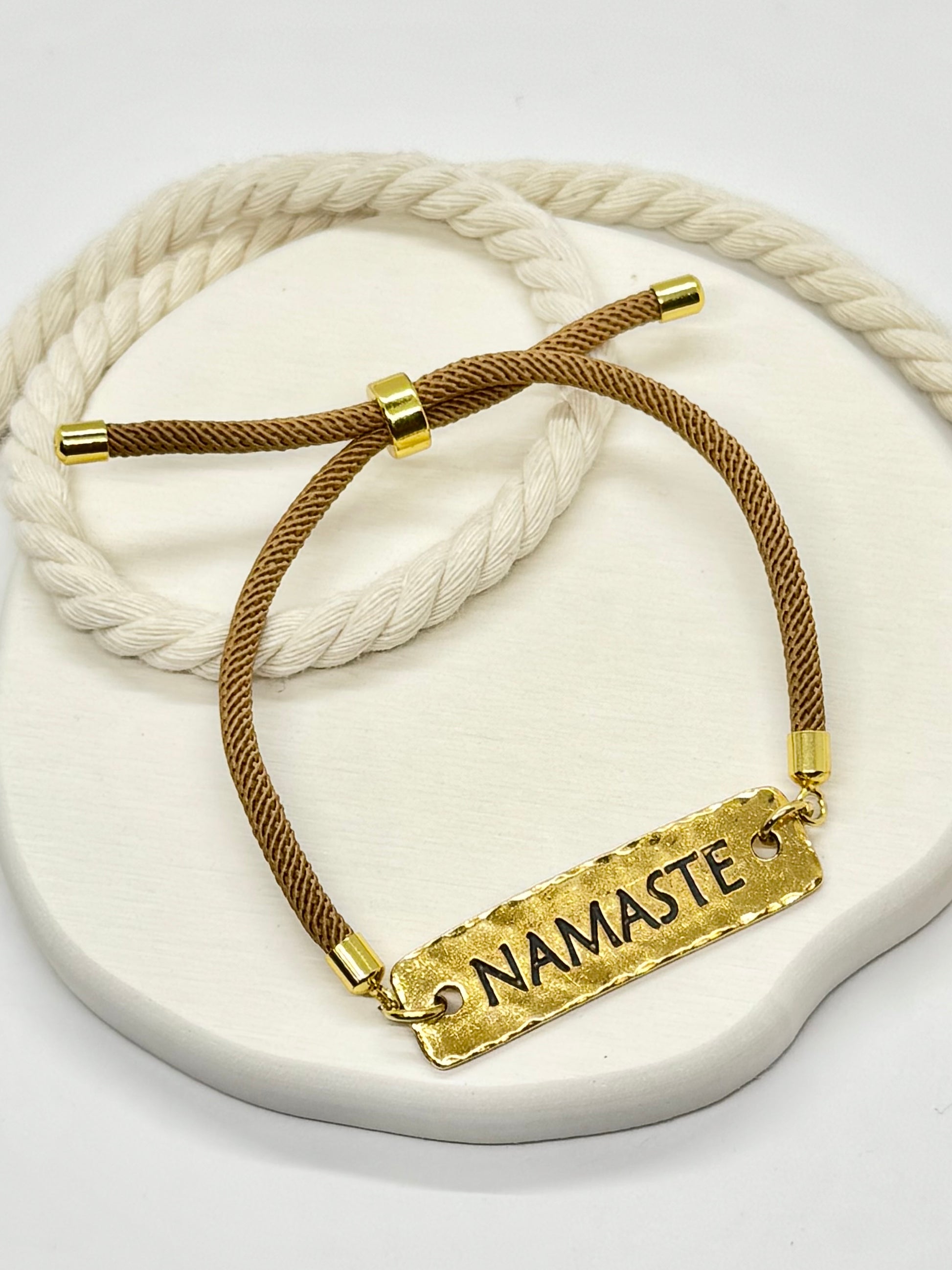 Bracelet with 'Namaste' tag on a white background