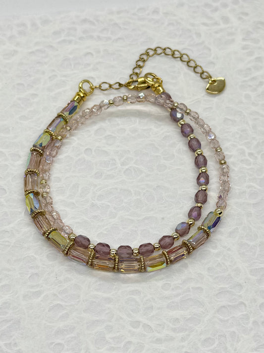 Multistrand beaded bracelet with gold accents on a textured white background