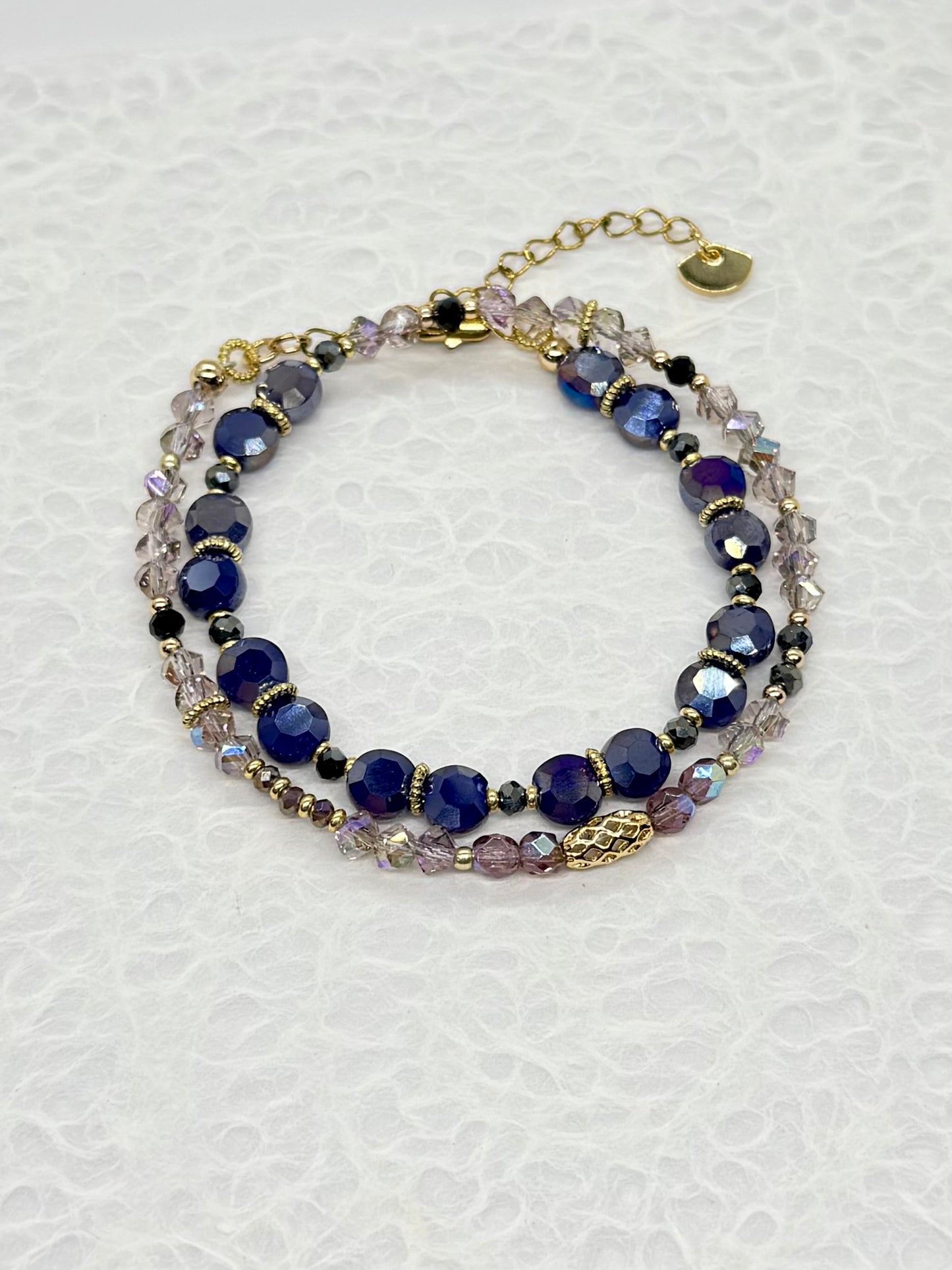 Multistrand bracelet with blue and clear beads on a white background