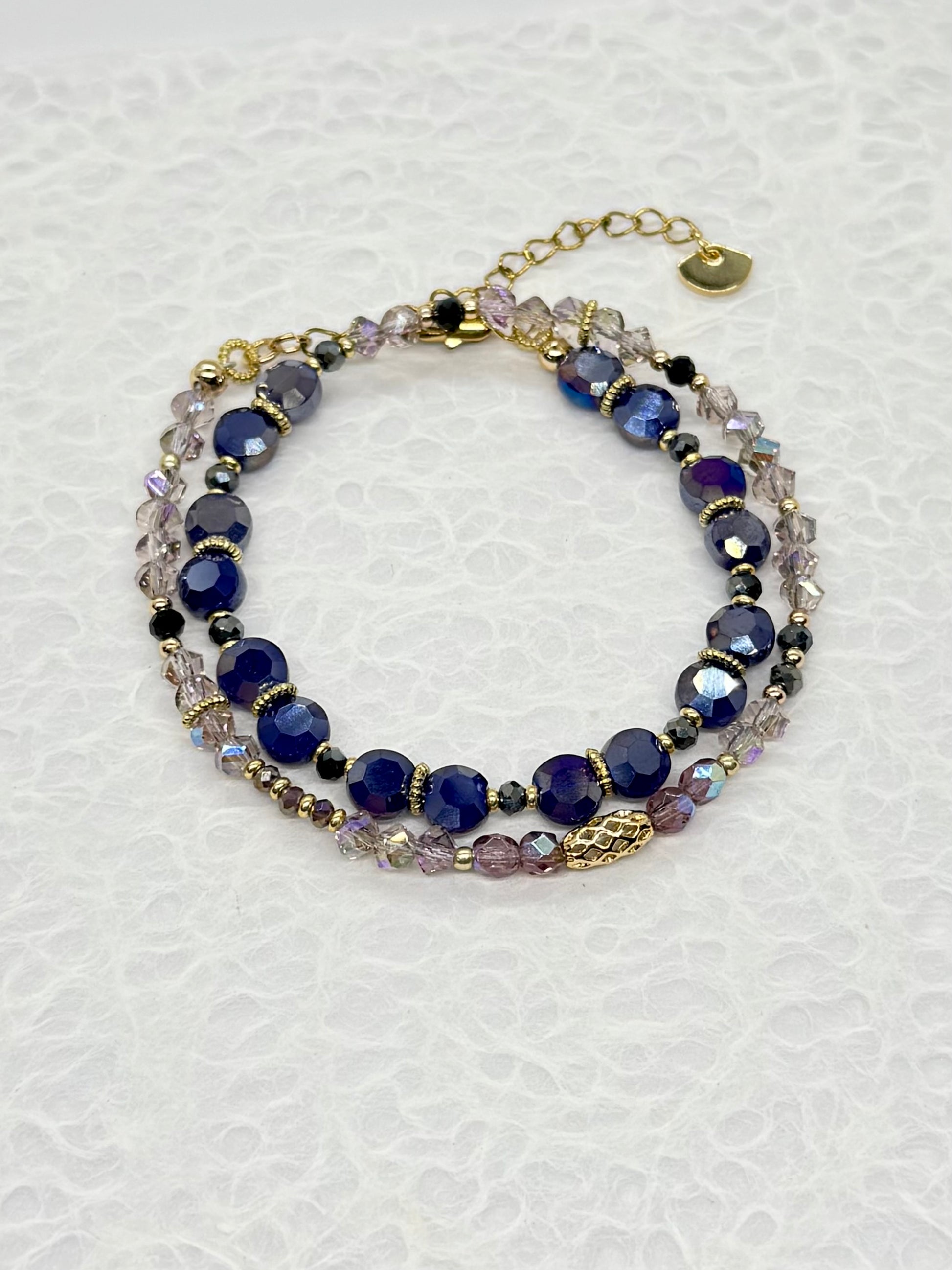 Multistrand bracelet with blue and clear beads on a white background
