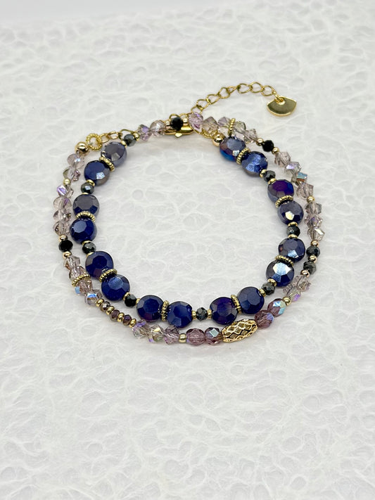 Multistrand bracelet with blue and clear beads on a white background