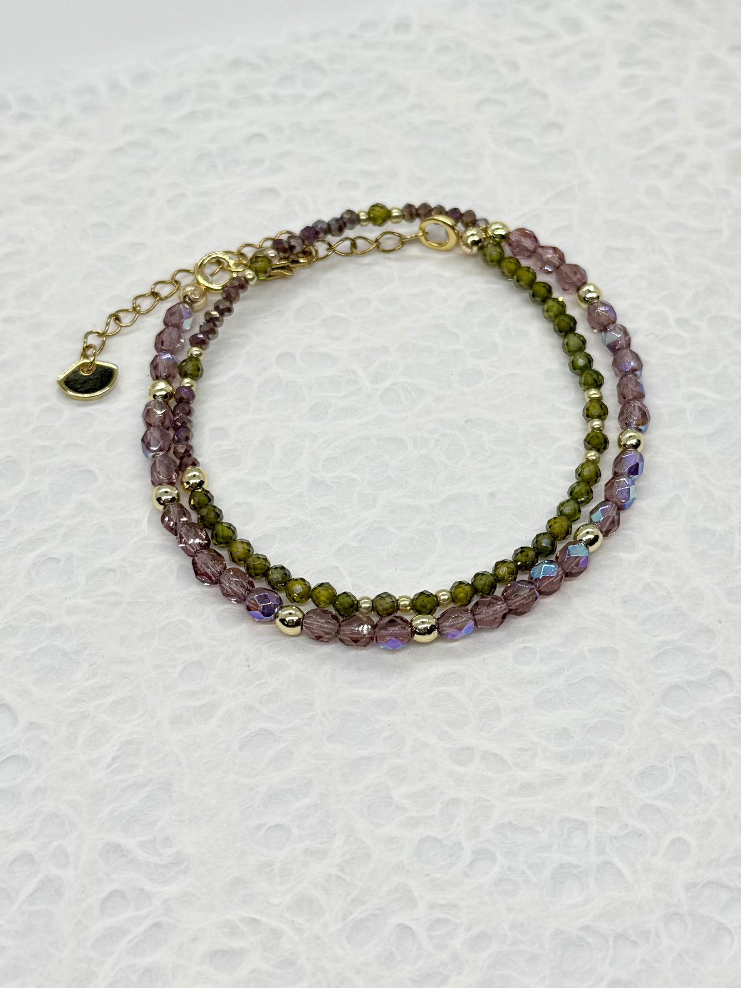 Multicolored beaded bracelet on a textured white background