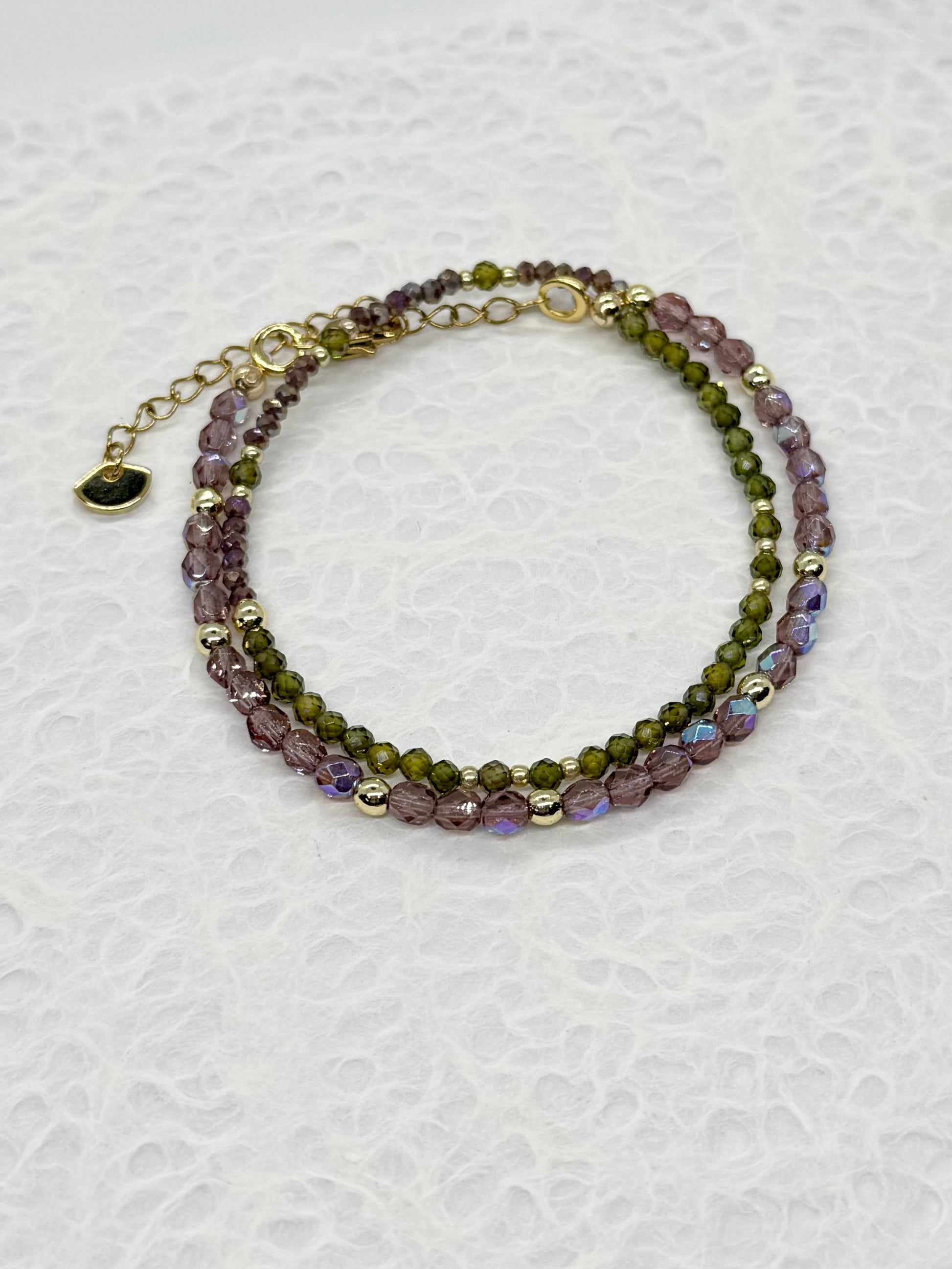 Multicolored beaded bracelet on a textured white background