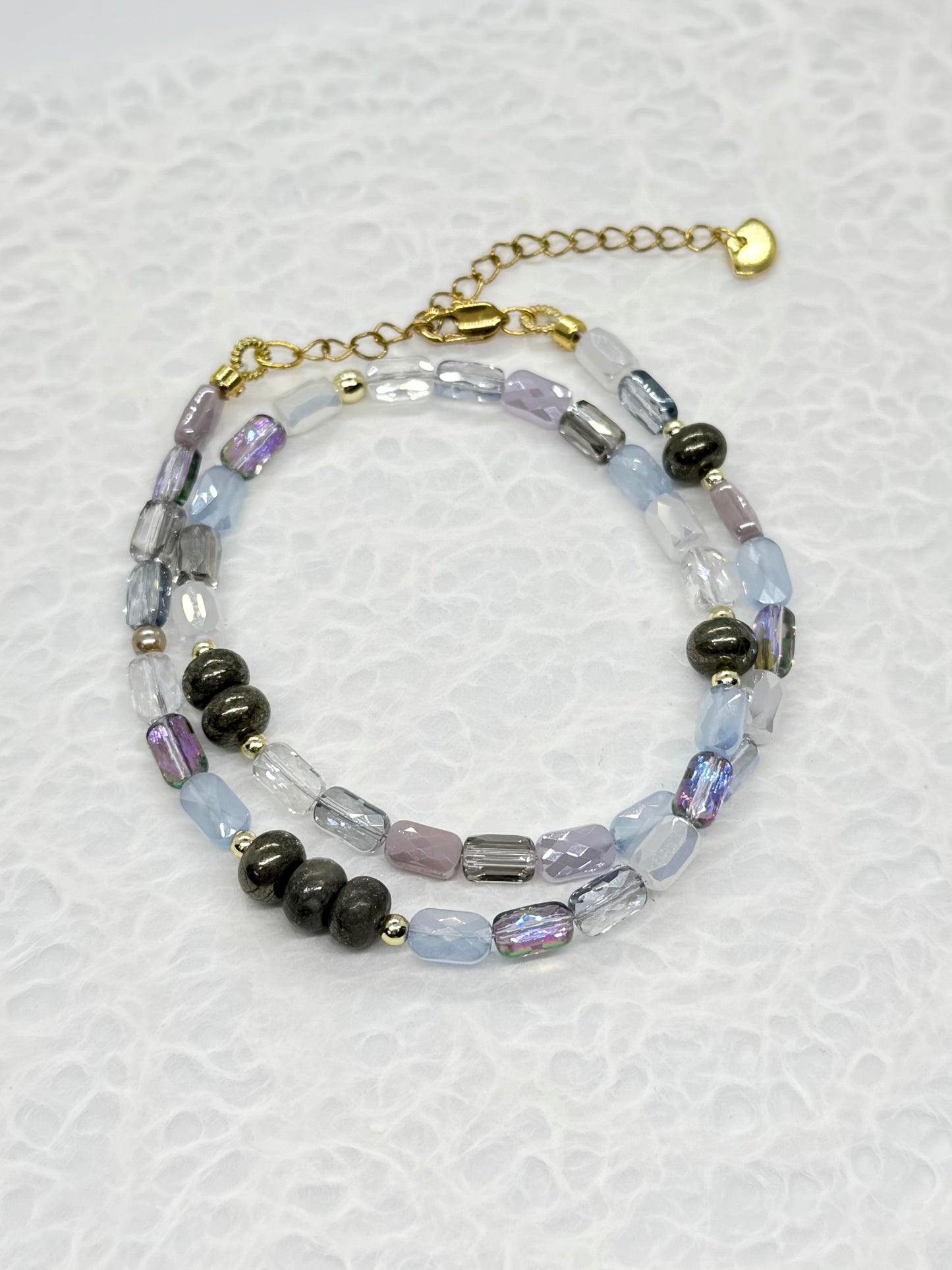 Beaded bracelet with black and clear beads on a white background