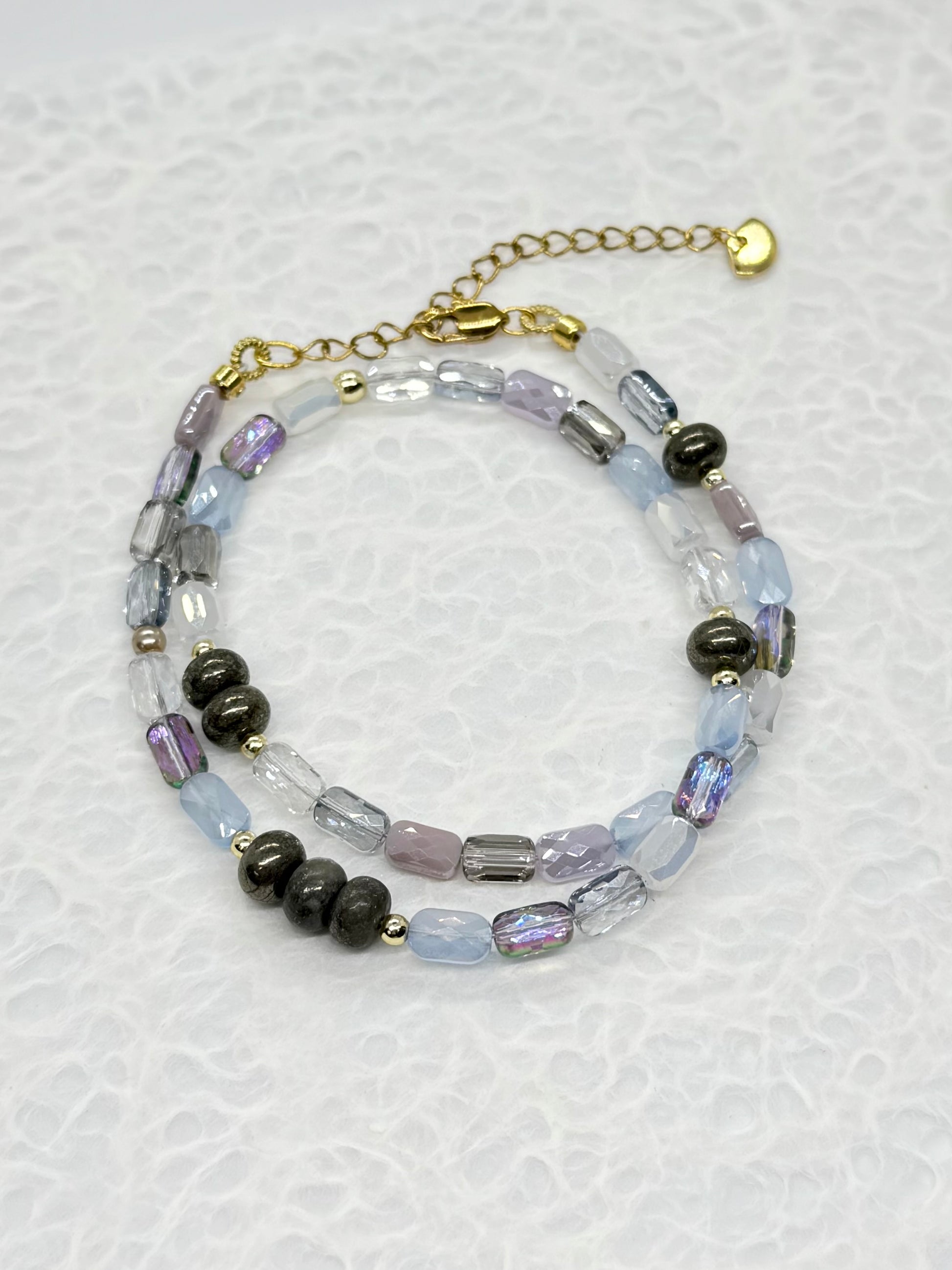 Beaded bracelet with black and clear beads on a white background