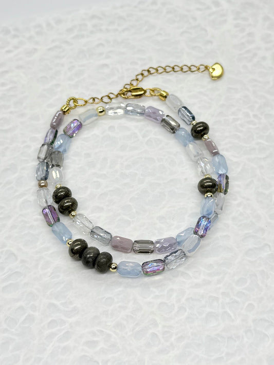 Beaded bracelet with black and clear beads on a white background