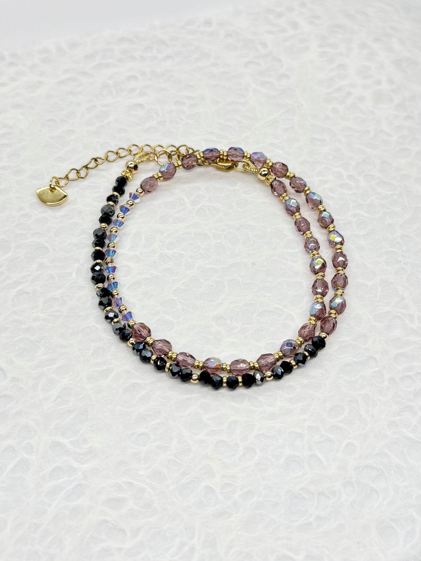 Multicolored beaded bracelet on a textured white background