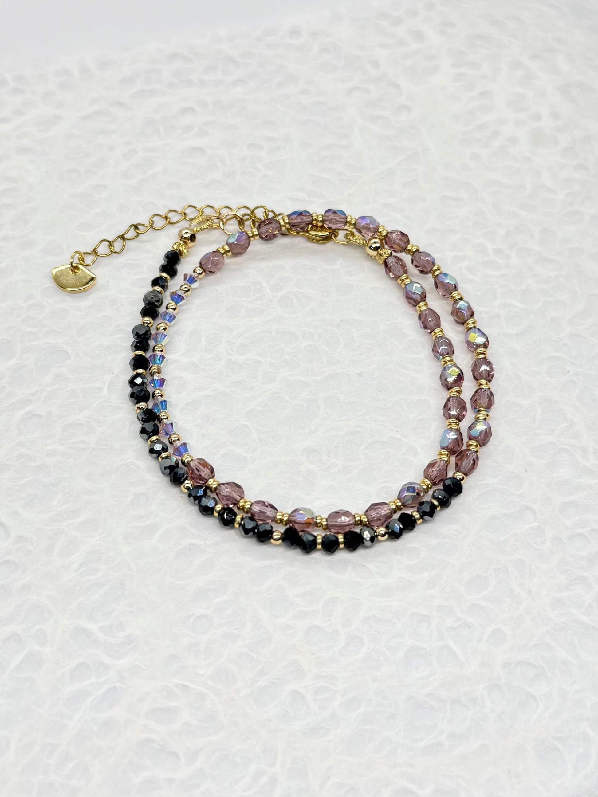 Multicolored beaded bracelet on a textured white background
