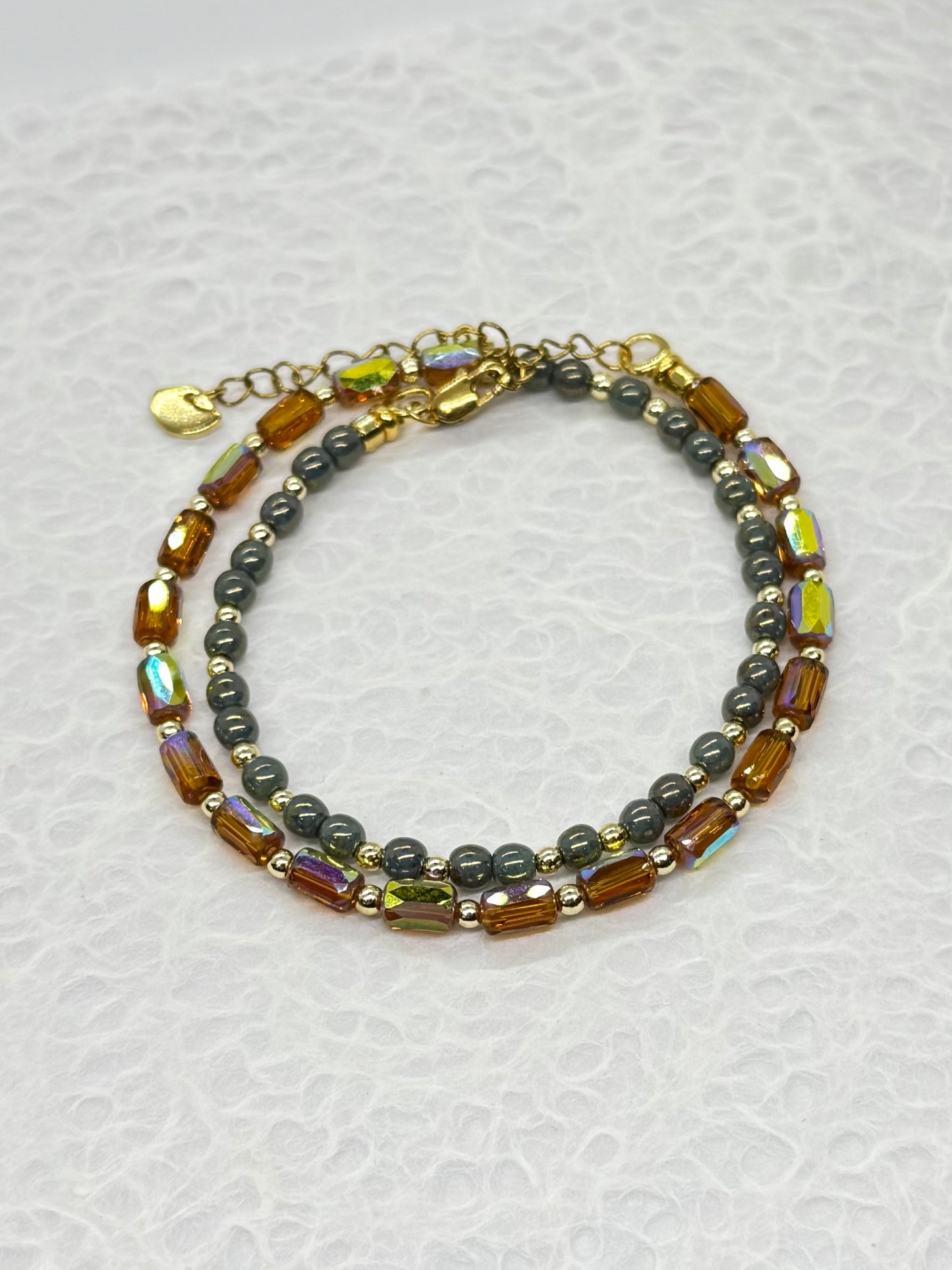 Multicolored beaded bracelet on a textured white background