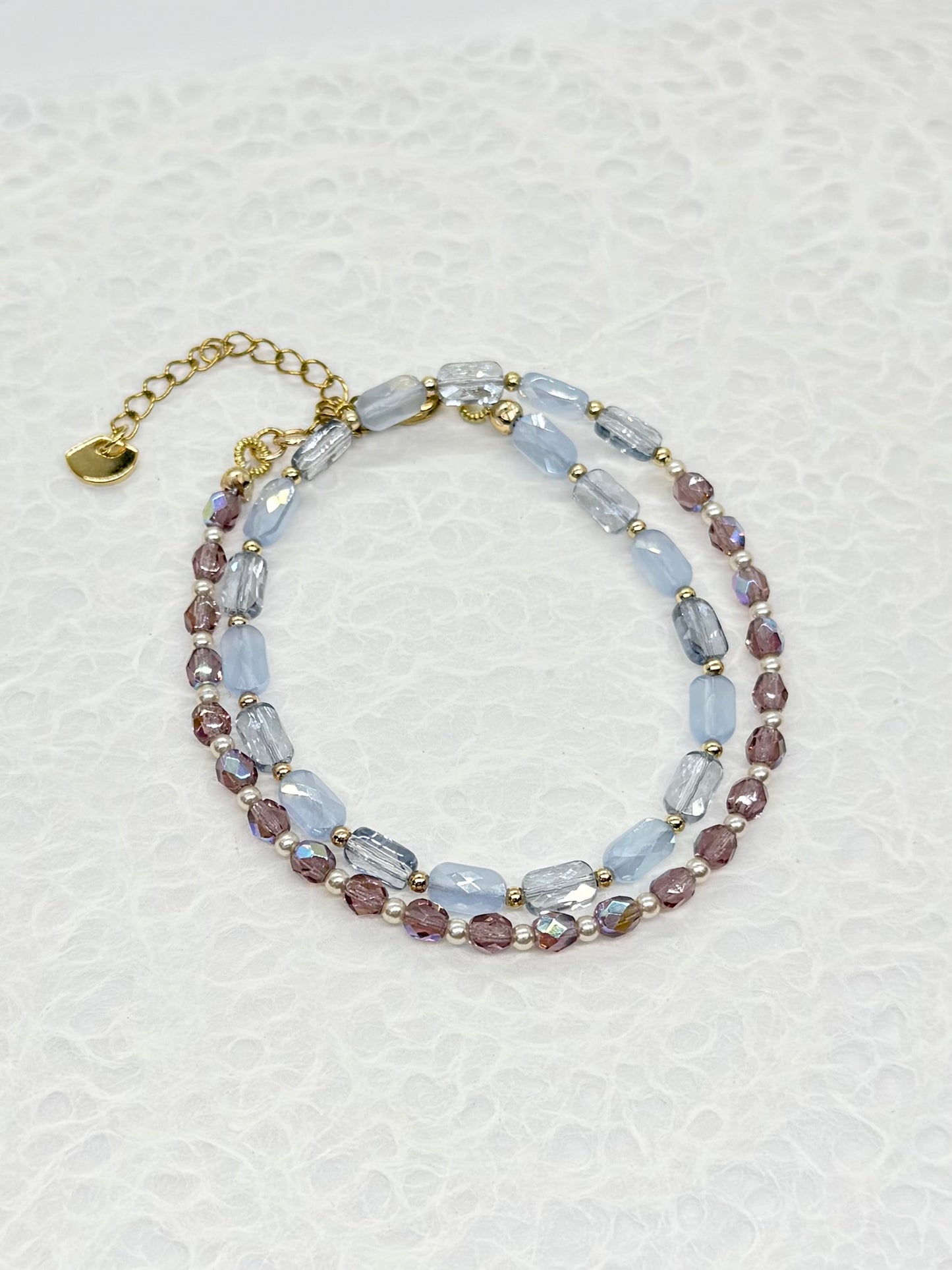 Multicolored beaded bracelet on a textured white background
