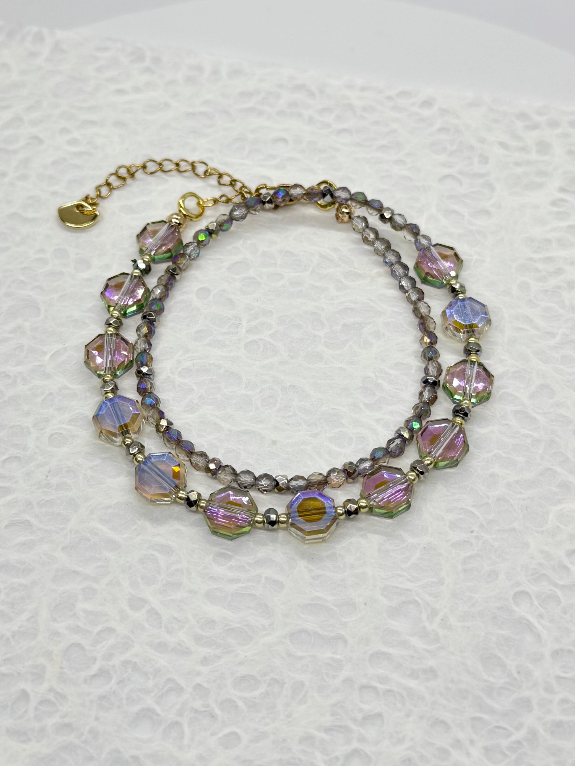 Multistrand beaded bracelet with colorful beads on a textured white background