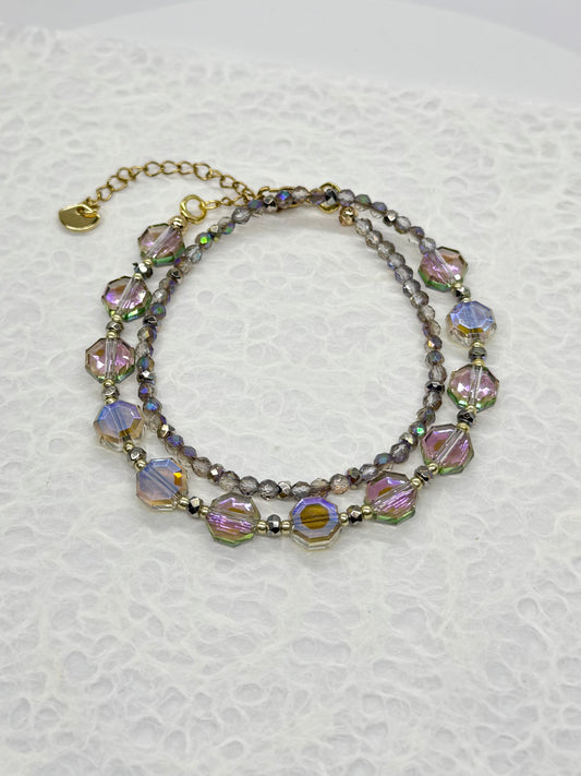 Multistrand beaded bracelet with colorful beads on a textured white background