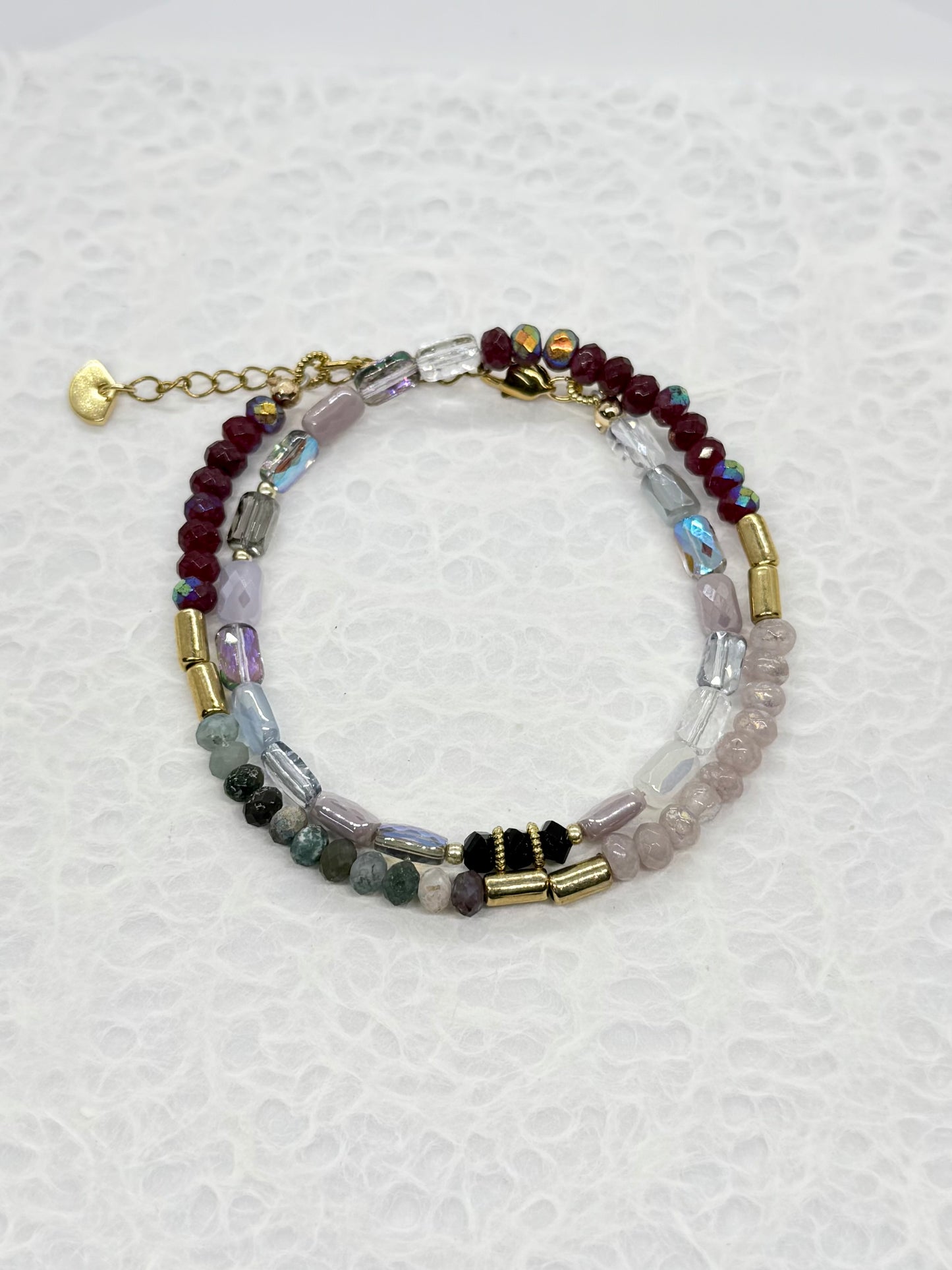 Multicolored beaded bracelet on a textured white background