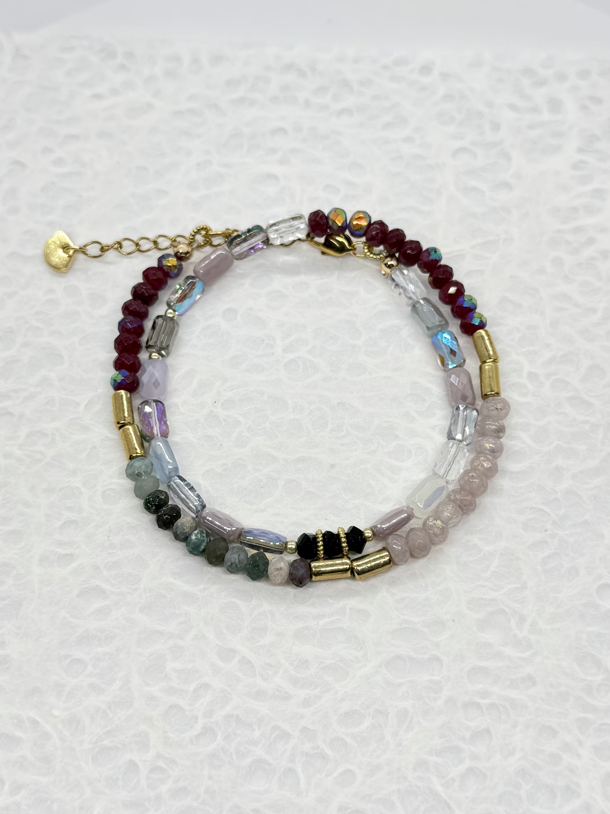Multicolored beaded bracelet on a textured white background