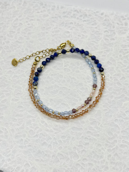 Stack of beaded bracelets on a textured white surface
