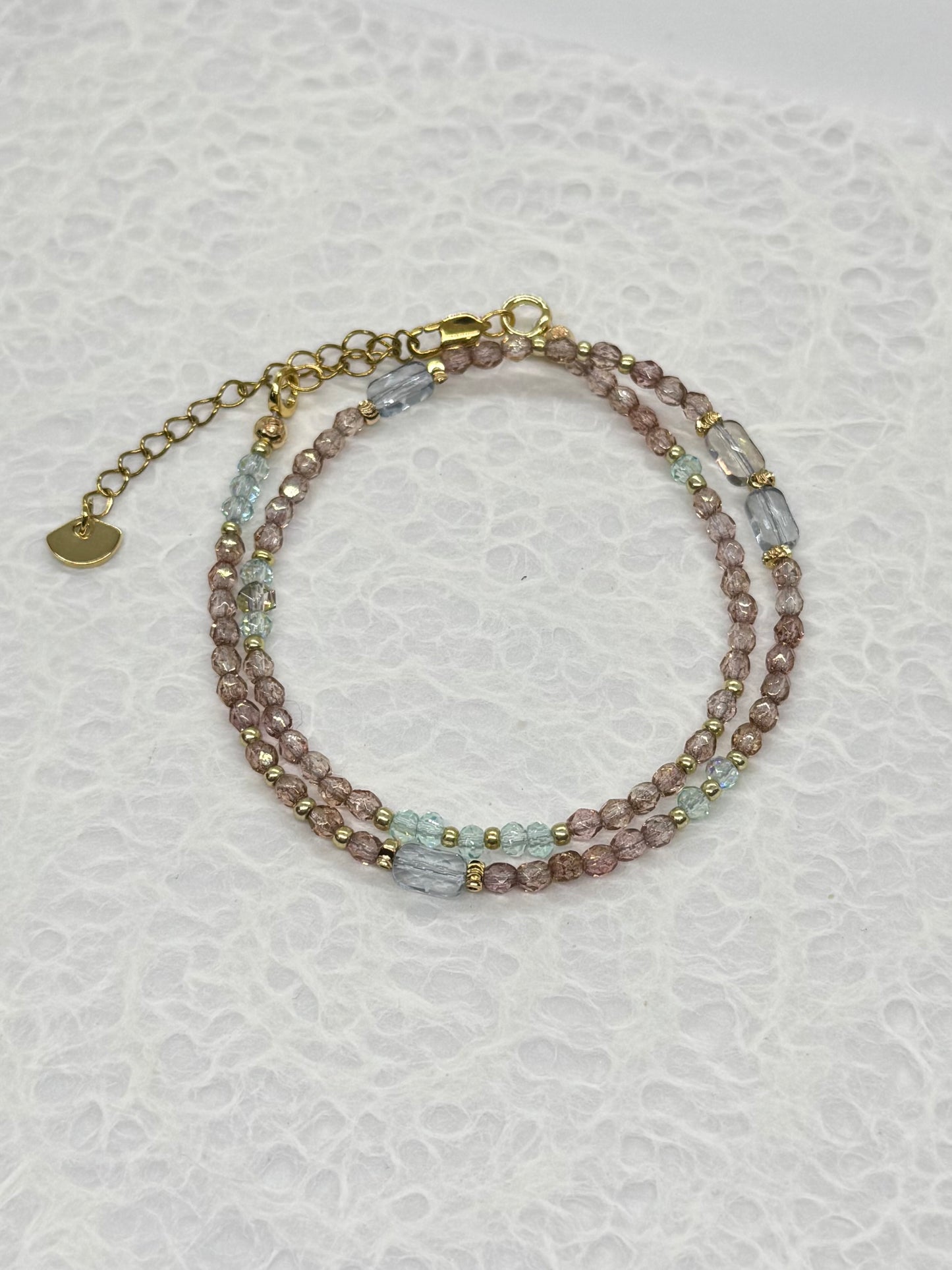 Multicolored beaded bracelet on a textured white background