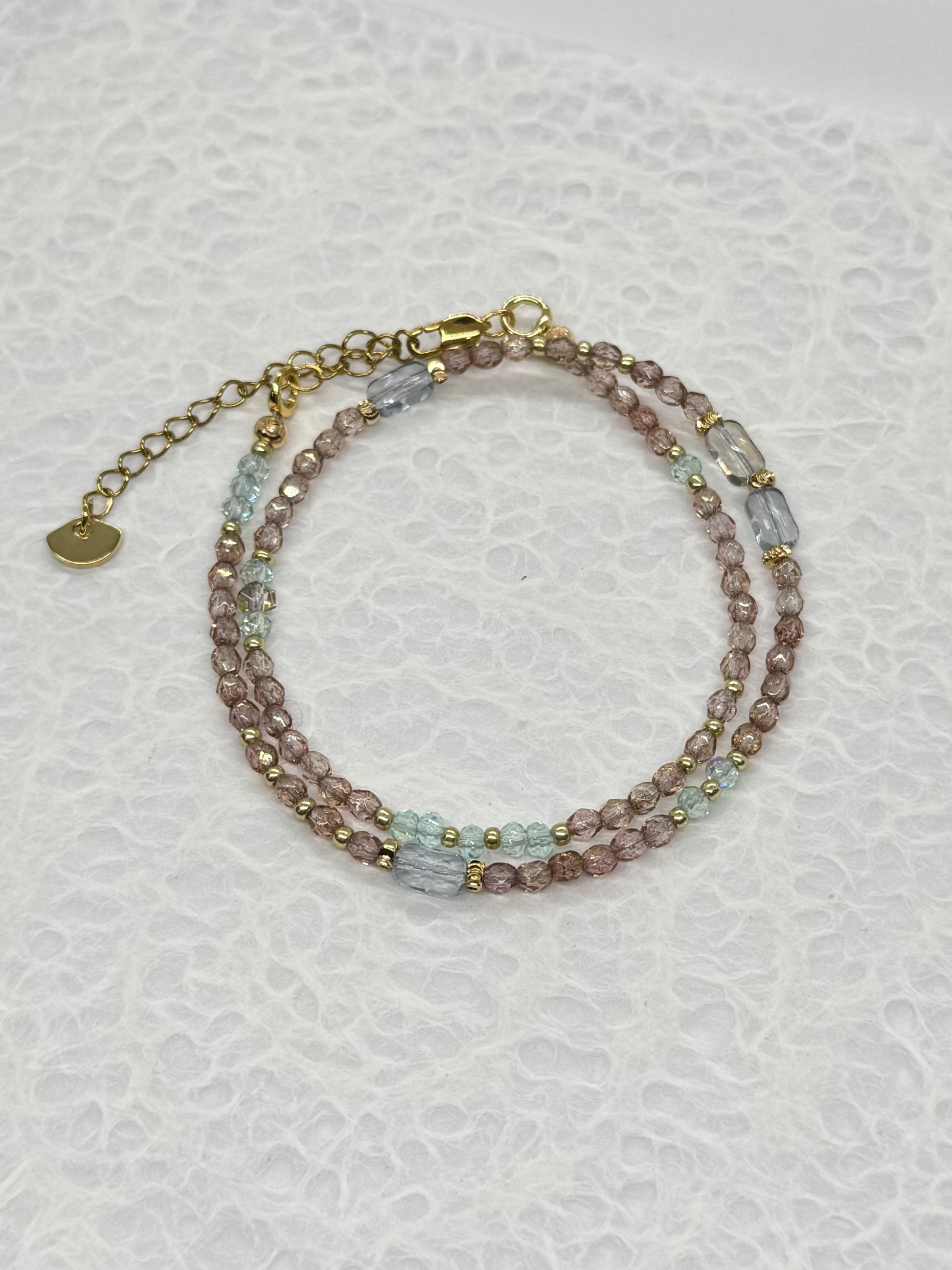 Multicolored beaded bracelet on a textured white background