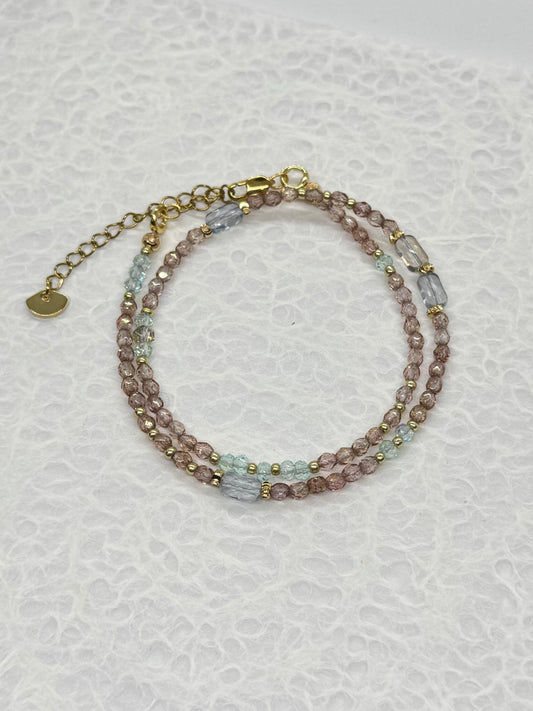 Multicolored beaded bracelet on a textured white background