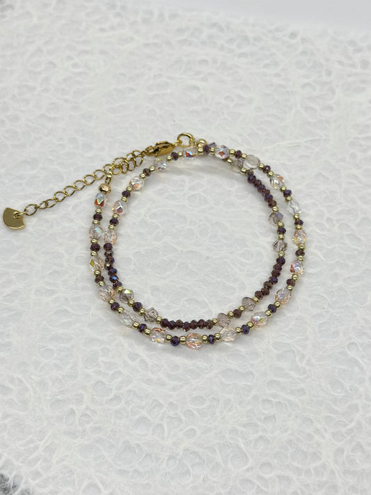 Stack of beaded bracelets on a textured white surface