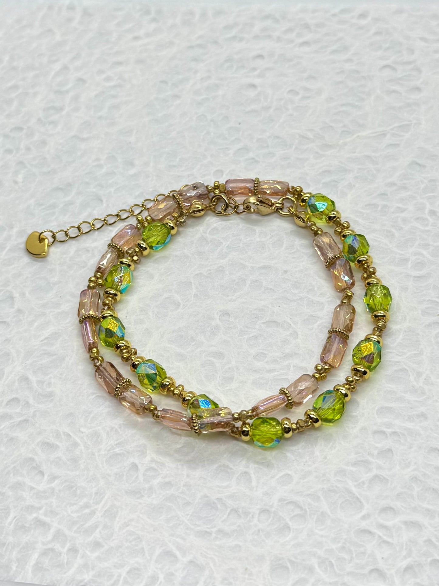 Multicolored beaded bracelet on a textured white background