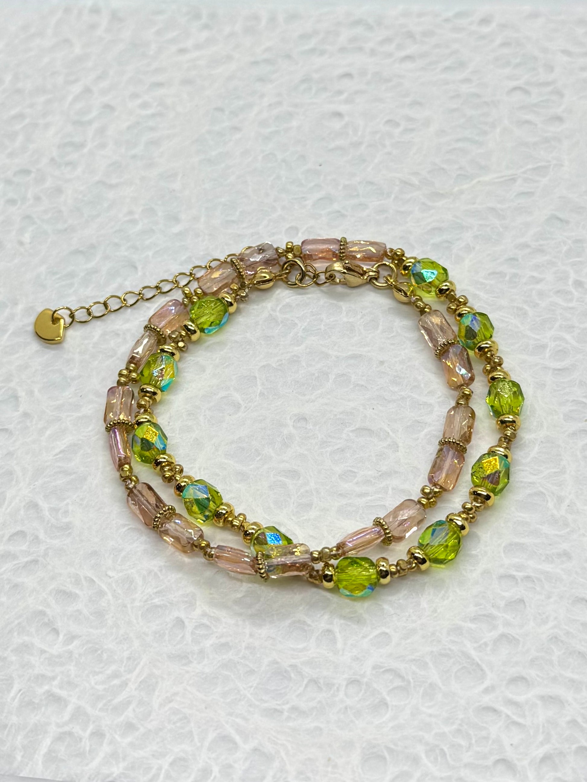 Multicolored beaded bracelet on a textured white background