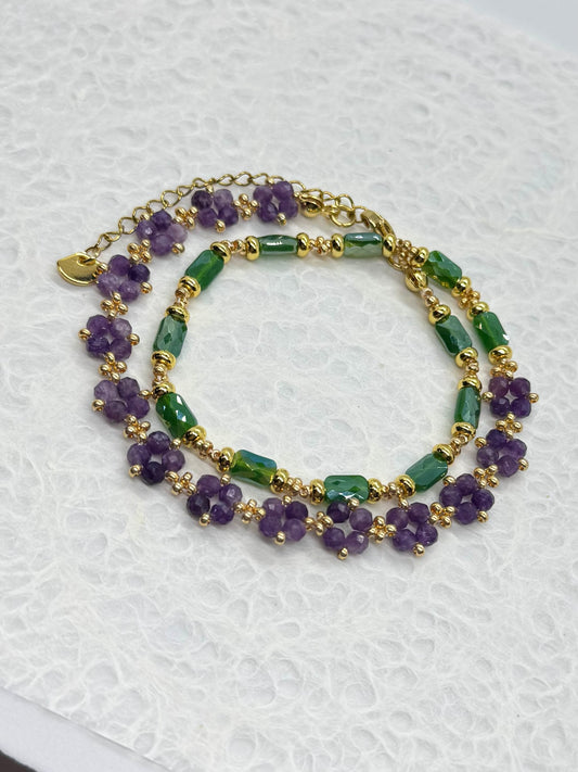 Two beaded bracelets with purple and green beads on a white background