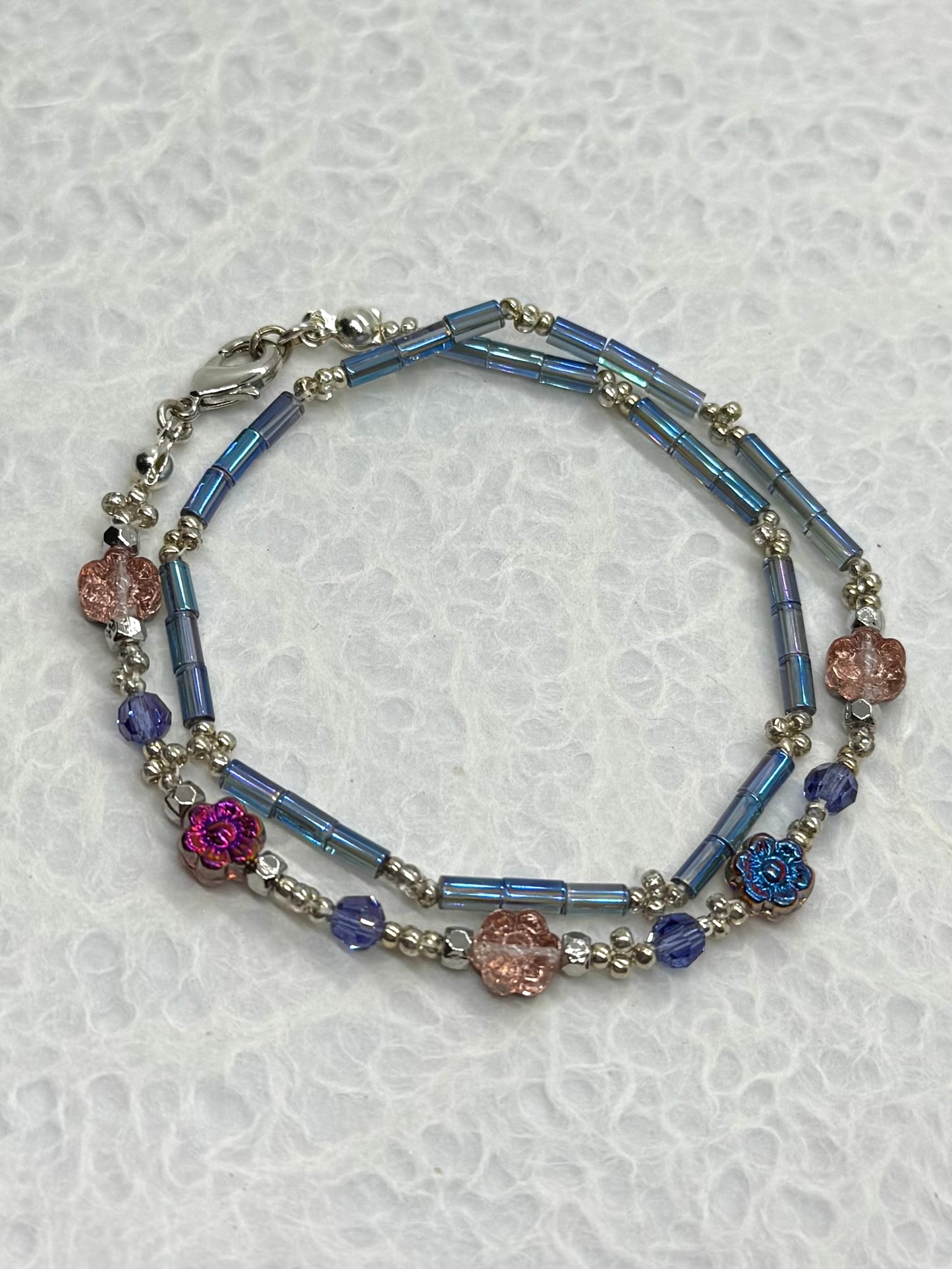 Multicolored beaded bracelet on a textured white background