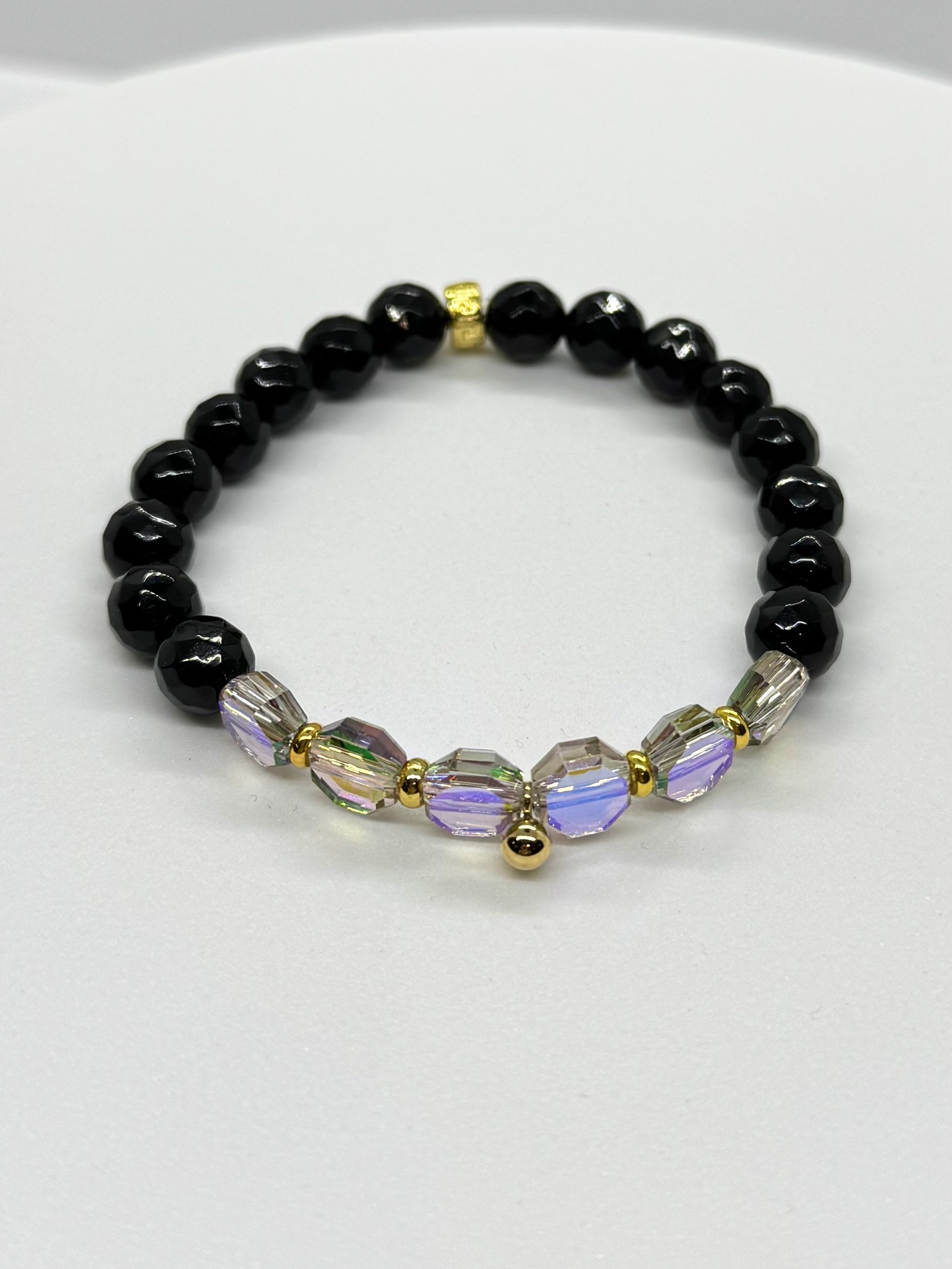 Black beaded bracelet with colorful beads on a white background