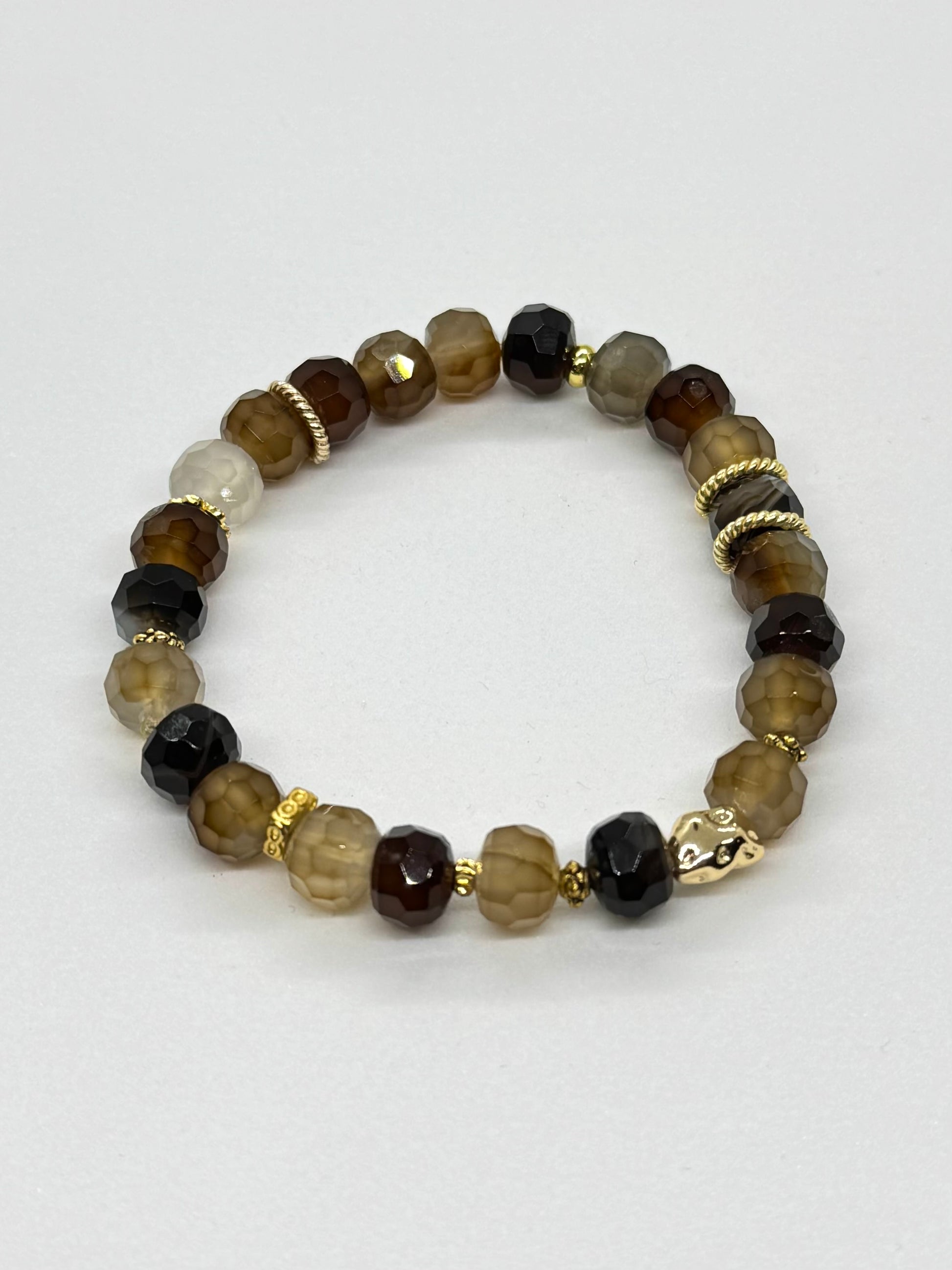 Beaded bracelet with brown and gold accents on a white background