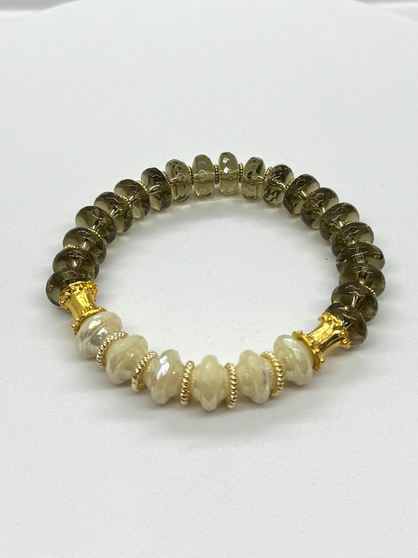 Beaded bracelet with gold accents on a white background