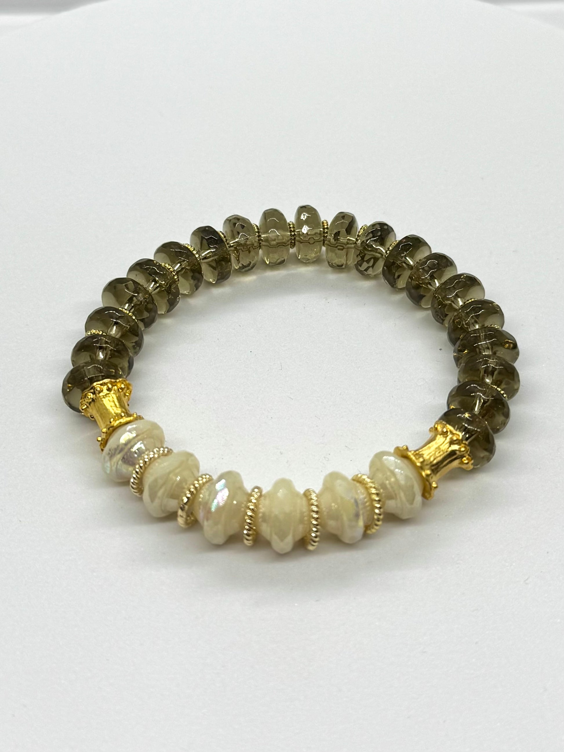 Beaded bracelet with gold accents on a white background