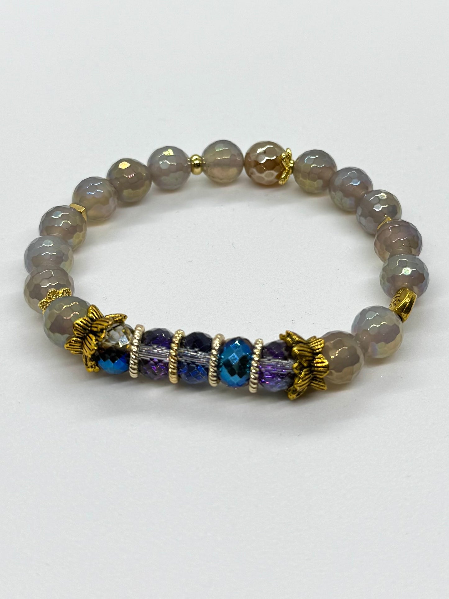 Bracelet with gray beads and blue and purple accents on a white background
