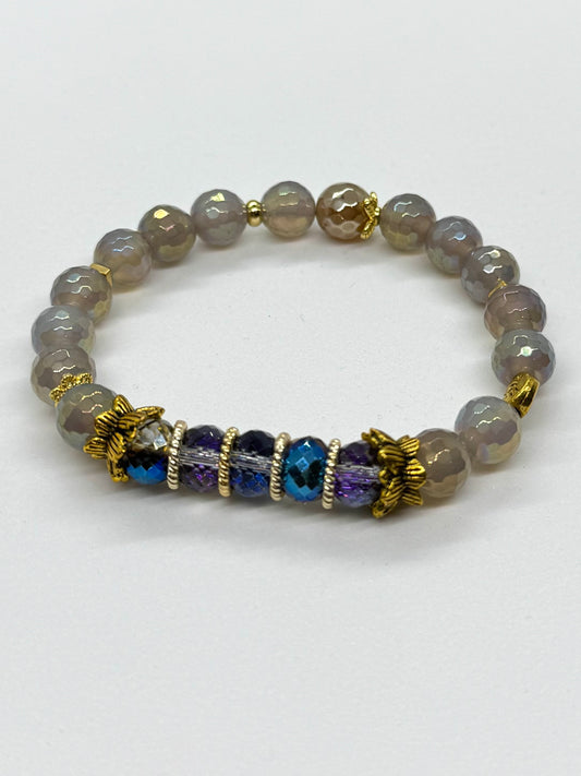 Bracelet with gray beads and blue and purple accents on a white background
