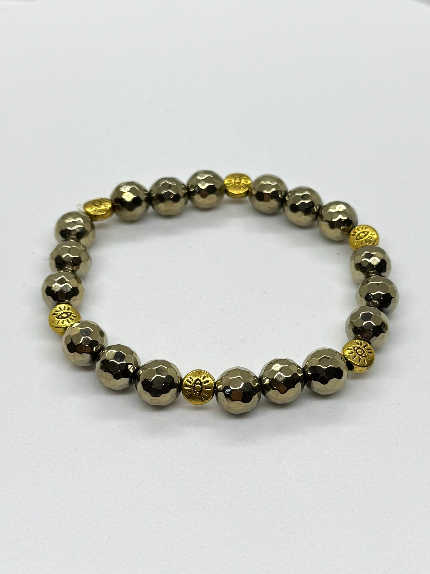 Bracelet with alternating gold and silver beads on a white background
