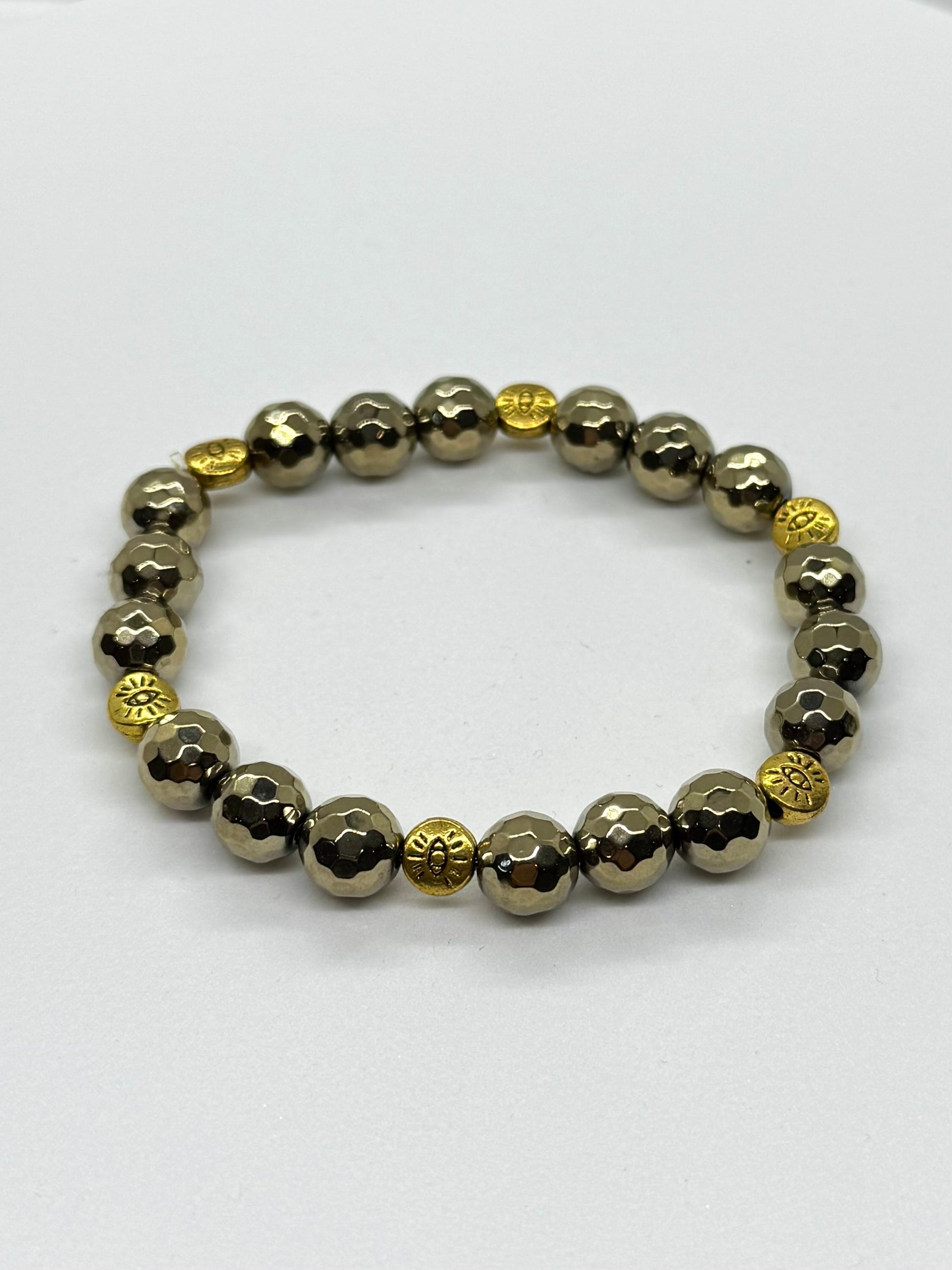 Bracelet with alternating gold and silver beads on a white background